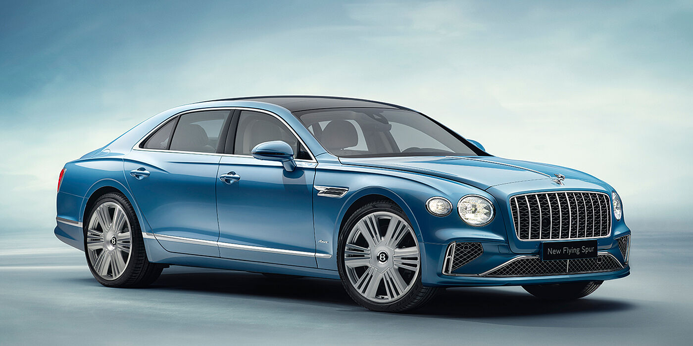 JCT600 Limited New Bentley Flying Spur Azure sedan front view in Light windsor blue by Mulliner paint with 22 inch Azure wheels and chrome exterior details